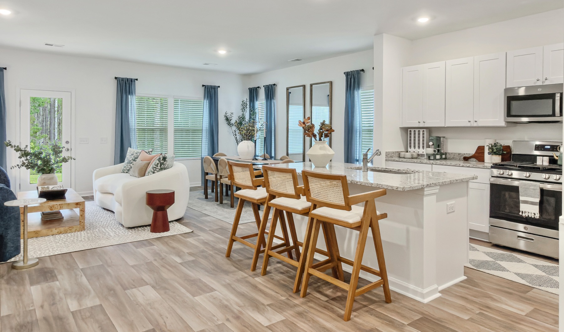 Kitchen with white cabinets and large island 