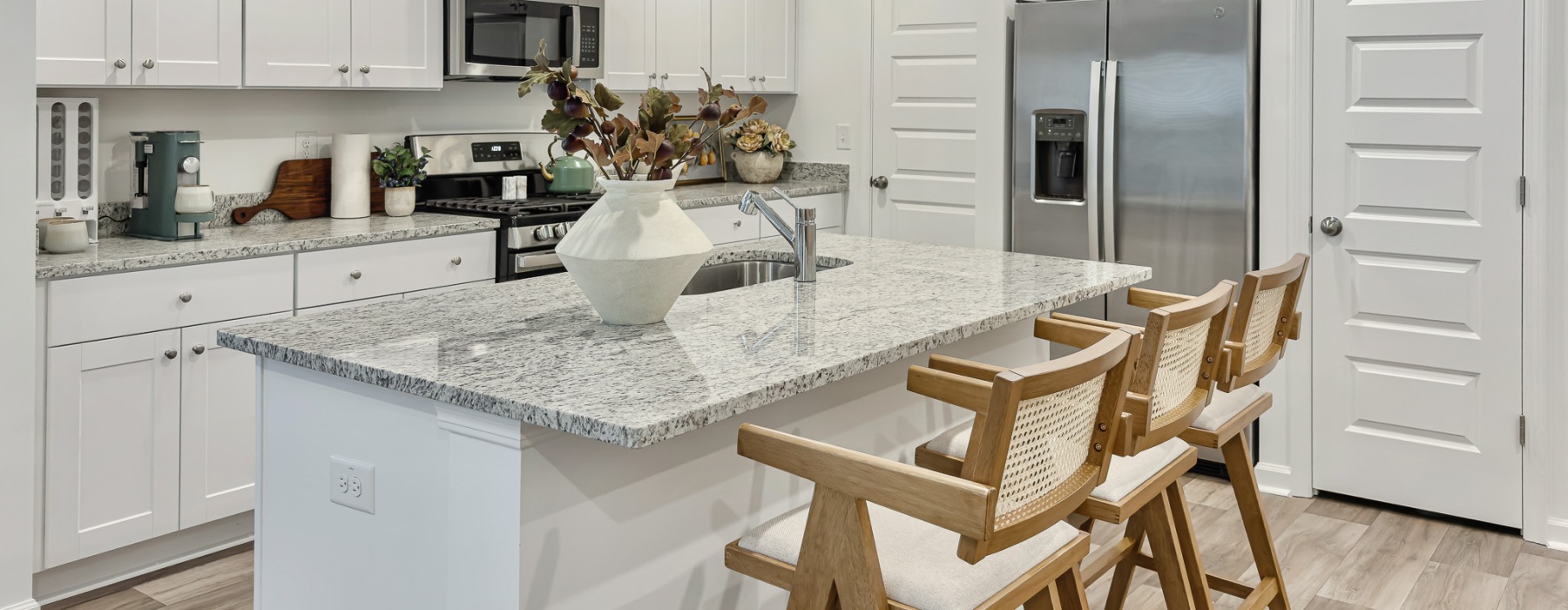 Large kitchen with white cabinets and ample island storage